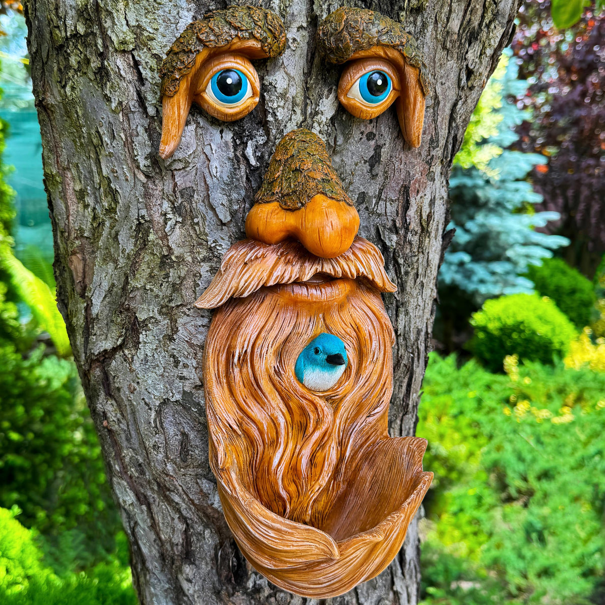 Mood Lab tree faces decor adds whimsy to your garden with an integrated bird feeder.