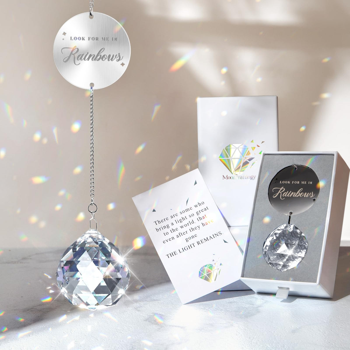 Mooncraftlogy clear crystal ball suncatcher displays a rainbow when sunlight hits it.