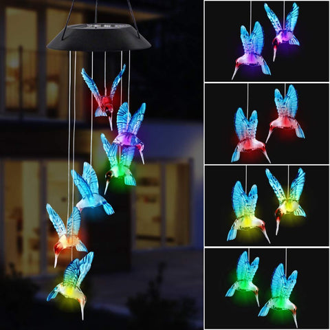 MorTime LED solar hummingbird wind chime in blue glass glows at night.