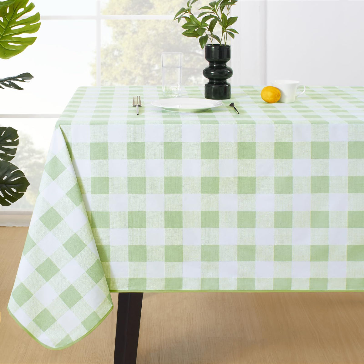 MOSAYT buffalo gingham tablecloth in sage green protects surfaces during outdoor meals.