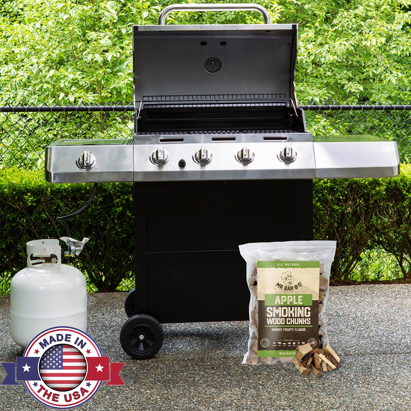 Mr. Bar-B-Q apple wood chunks on a grill releasing aromatic, sweet smoke