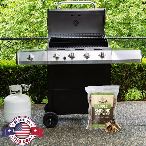 Mr. Bar-B-Q apple wood chunks on a grill releasing aromatic, sweet smoke