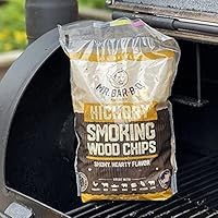 Hickory chips pouring into smoker for deep wood-smoked richness.