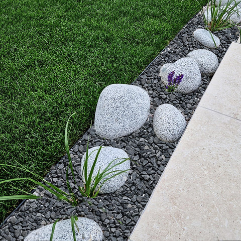 Mr. Fireglass gray bean pebbles provide low gloss ground cover.