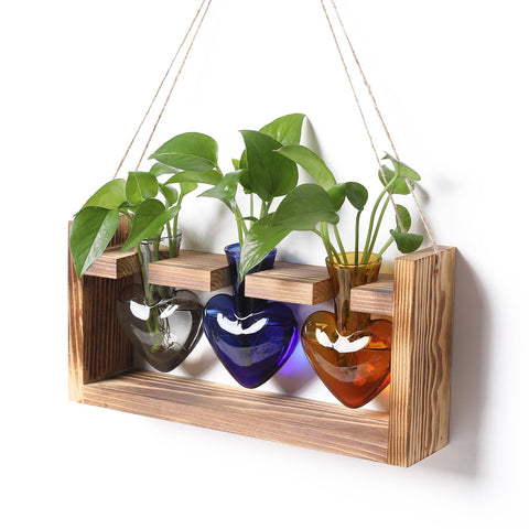 MTsigns heart-shaped vase on a natural wood stand, ideal for desk decor.