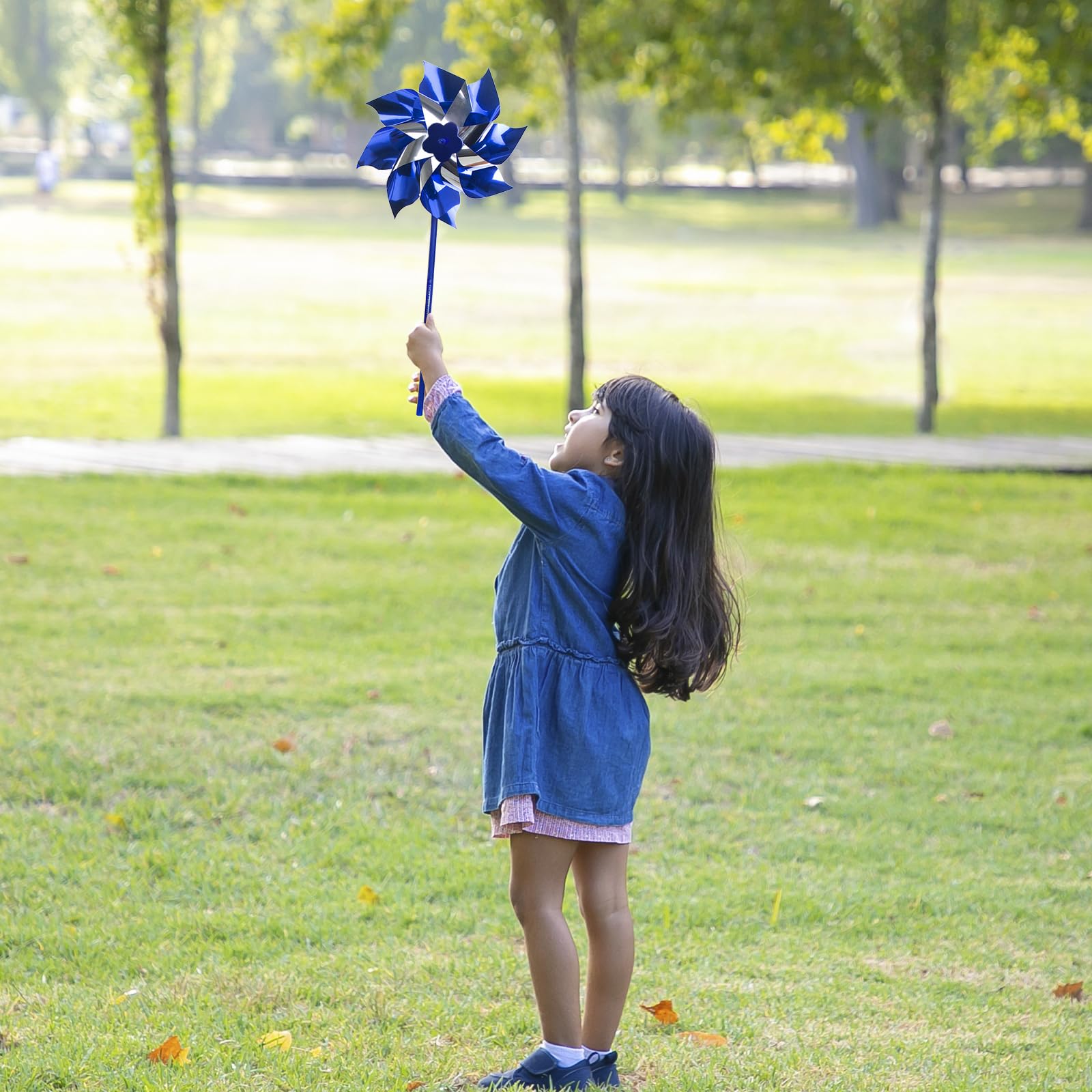 Muka blue pinwheel kids playing evokes motion and safe outdoor play.