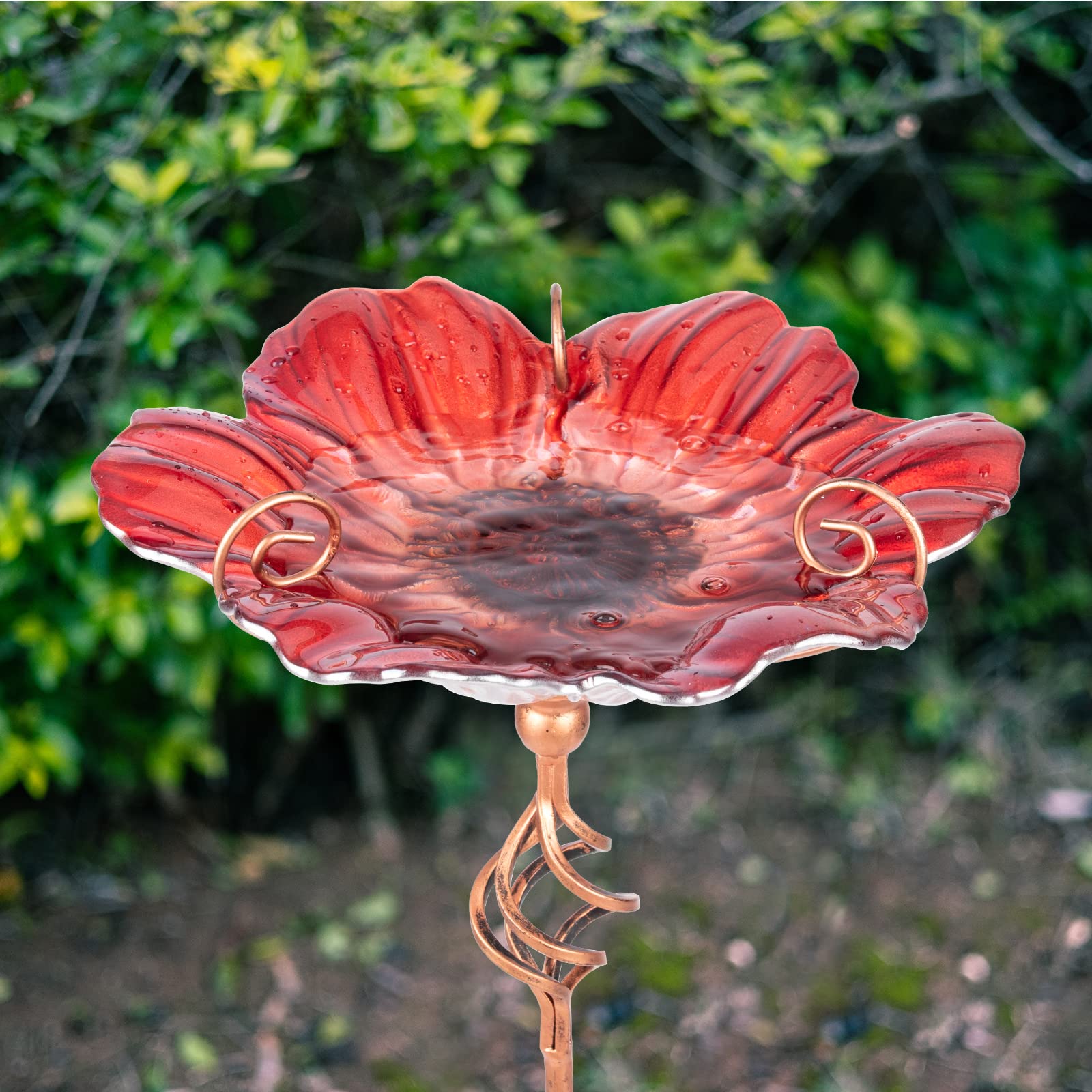 Handmade glass bowl with colorful pattern adds visual interest while attracting birds.