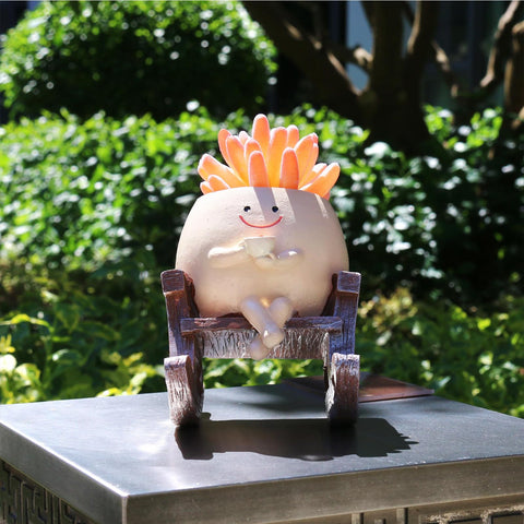 MUZZIOU Smiley Planter outdoors on patio, weather-resistant resin.