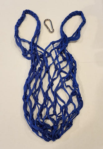 Muzzys blue coop treat bag mounted in a hanging setup above the run