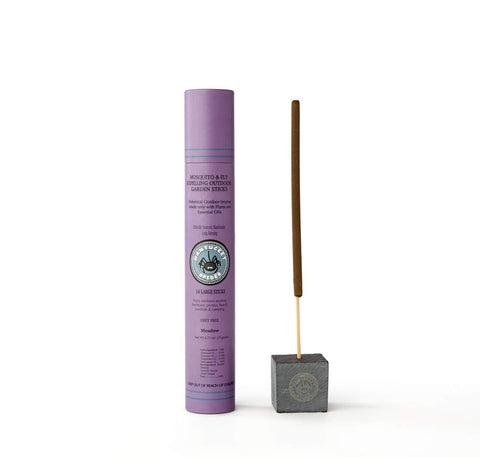 Nantucket Spider Mosquito Sticks lit outdoors with meadow scent to deter pests on a patio.