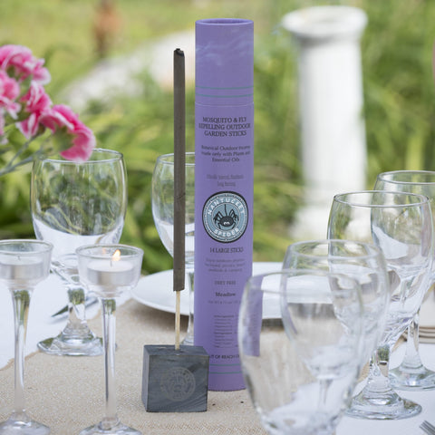 Nantucket Spider Mosquito Sticks shown with stone cube holder for stable outdoor use.