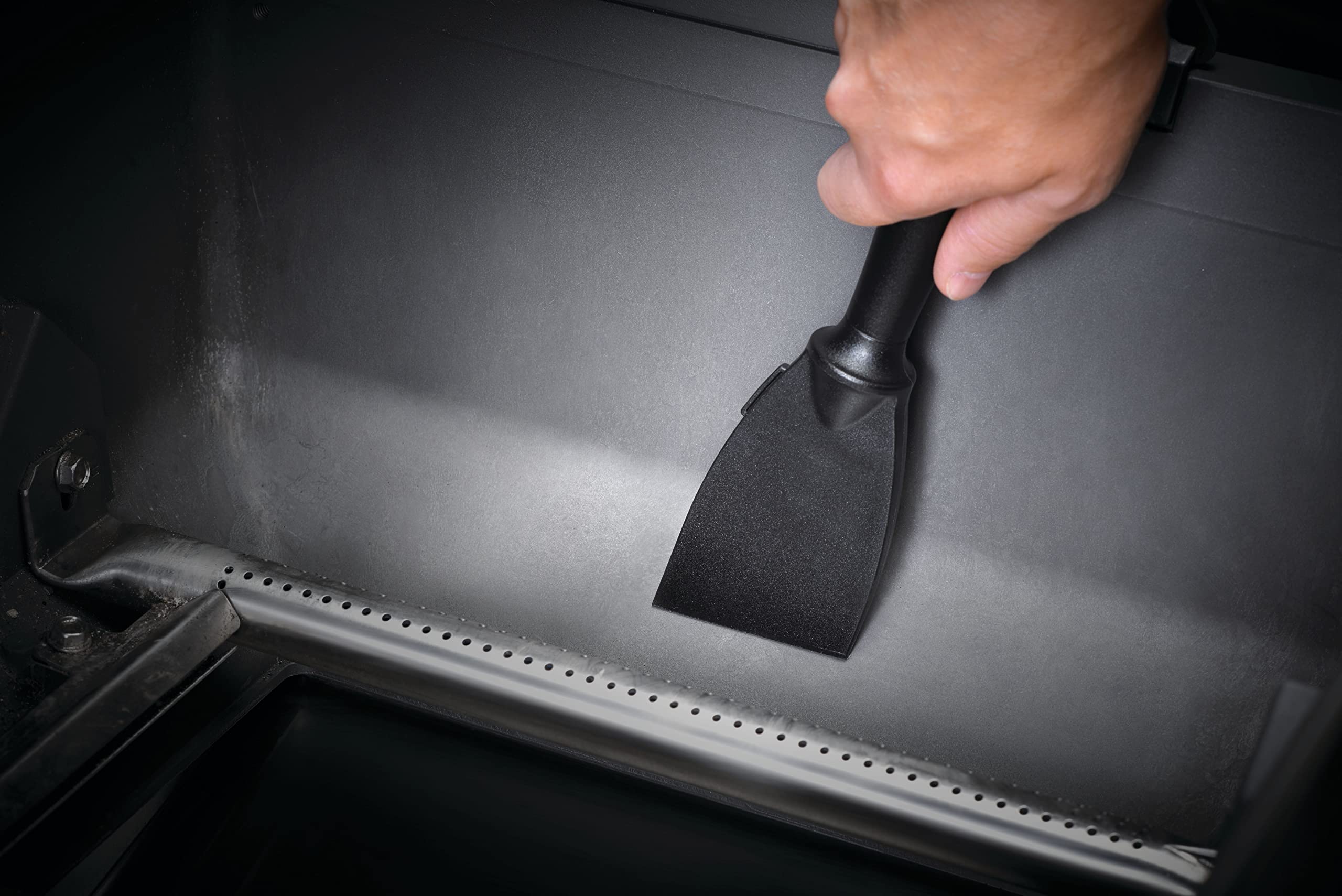 Napoleon cleaning tools set in action for efficient grill maintenance.