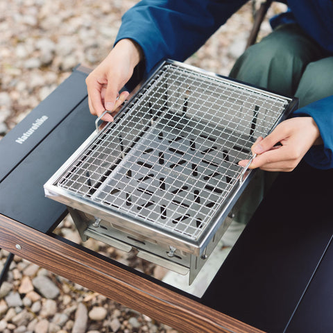 Naturehike folding BBQ grill with carry bag, easy to transport for camping trips.