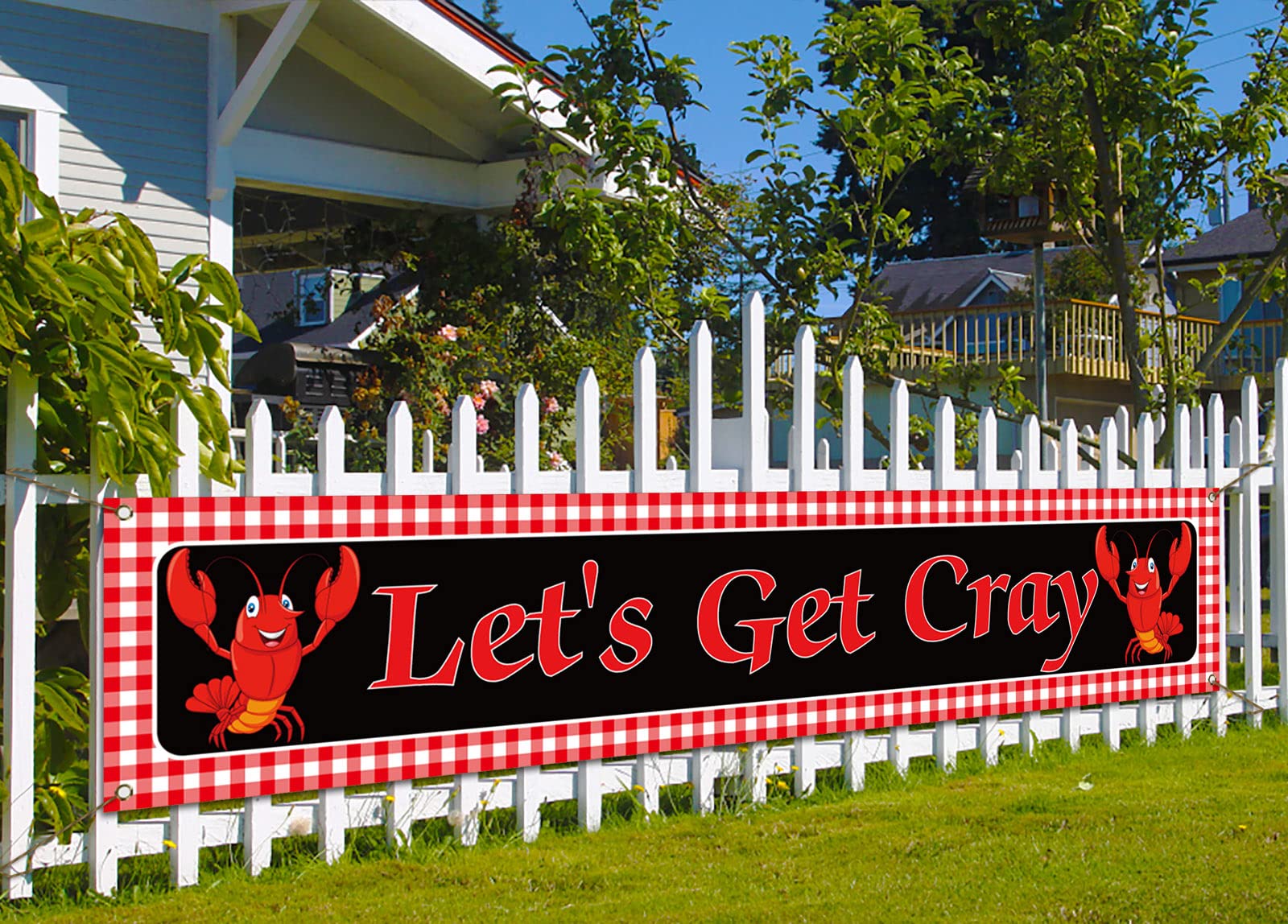 Nepnuser crawfish banner on fence for outdoor party decor, enhancing ambiance.