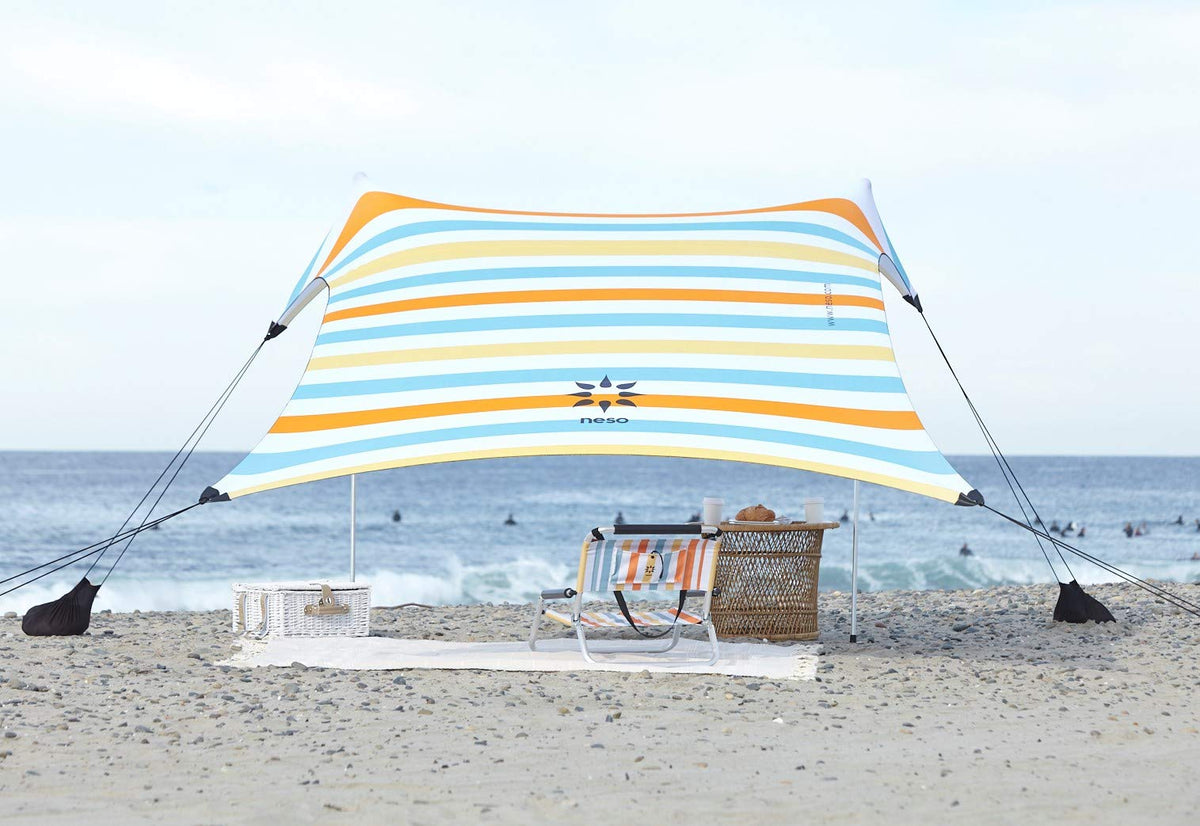 Neso portable beach tent with sand anchor provides stable shade on sunny beaches.