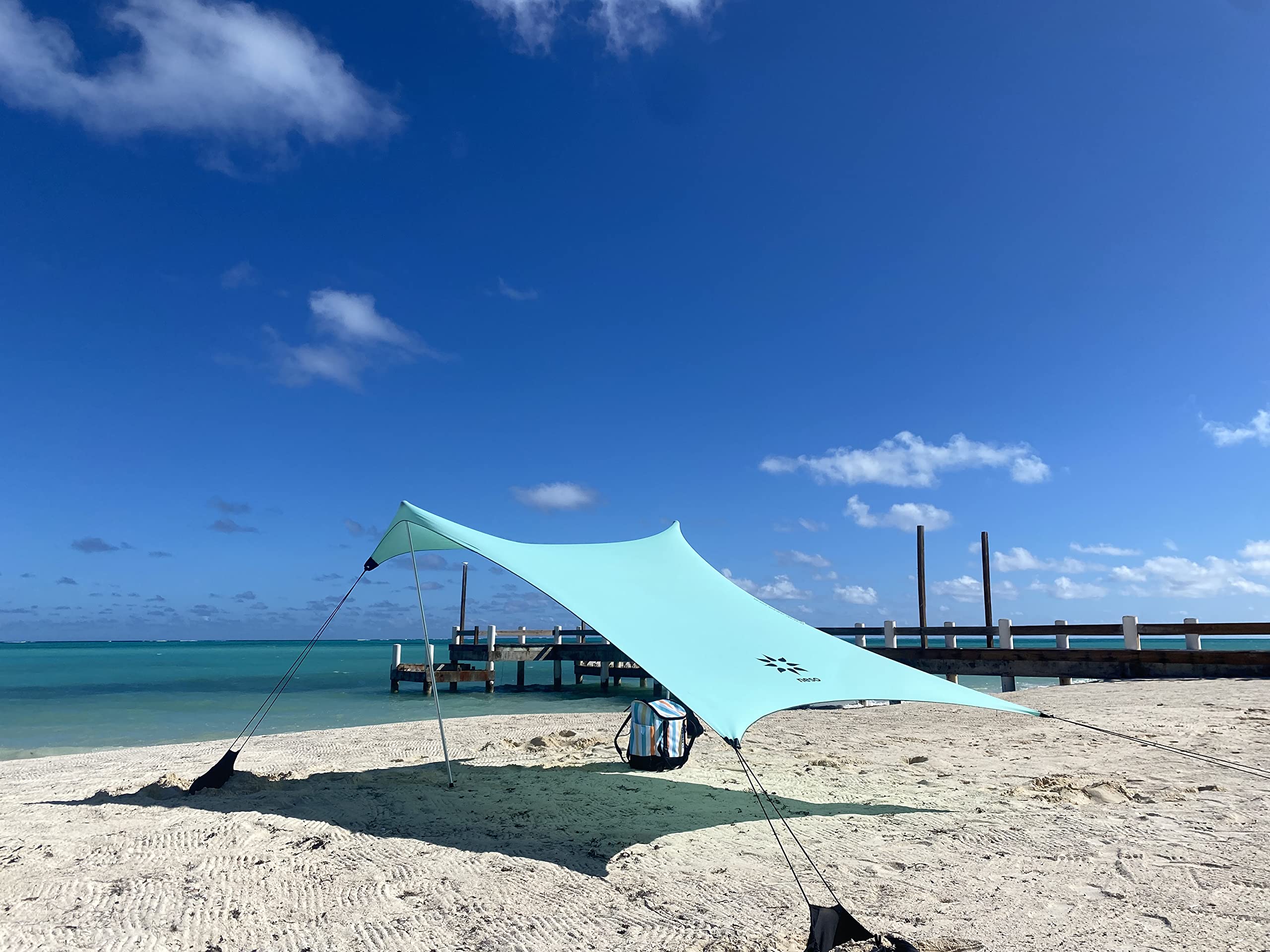 Neso sand-anchor system keeps your shade stable on windy beach days.