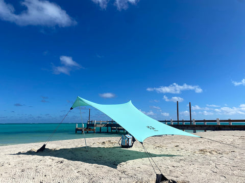 Neso sand-anchor system keeps your shade stable on windy beach days.