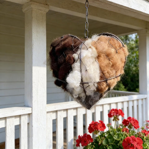 Nesting material frame with chain hangs easily from branches