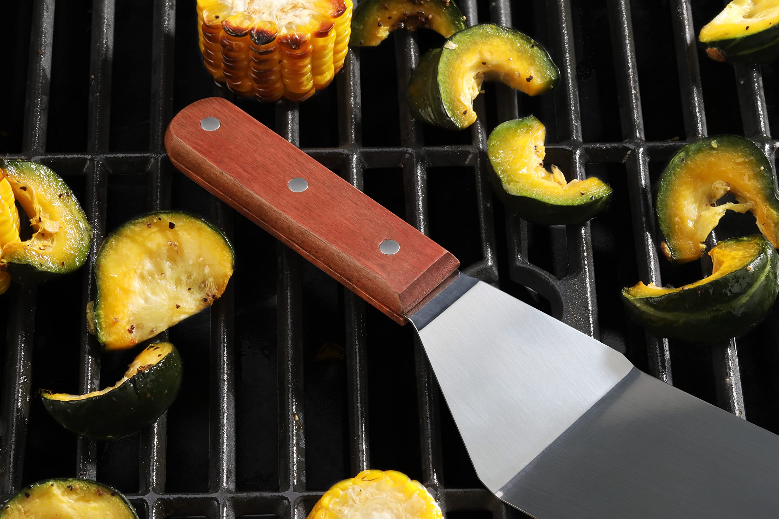 New Star Foodservice turner in use on a hot grill