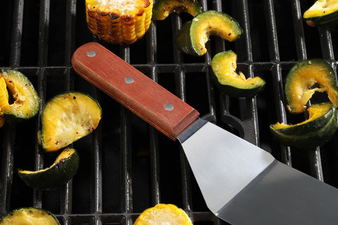 New Star Foodservice turner in use on a hot grill