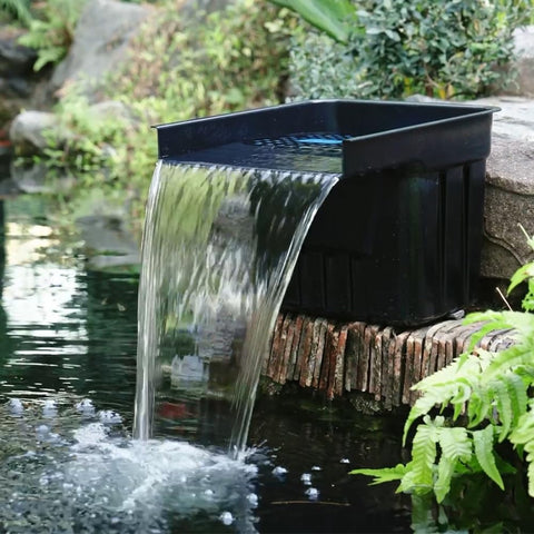 NFESOLAR hidden waterfall blends into landscape for a natural-looking garden feature.
