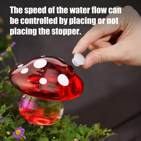 NiHome green glass mushroom watering bulb blends with greenery while hydrating