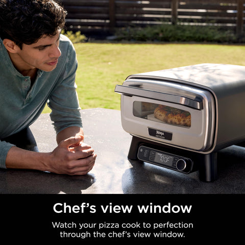 Ninja Artisan Outdoor Pizza Oven with stone and bake pan in use