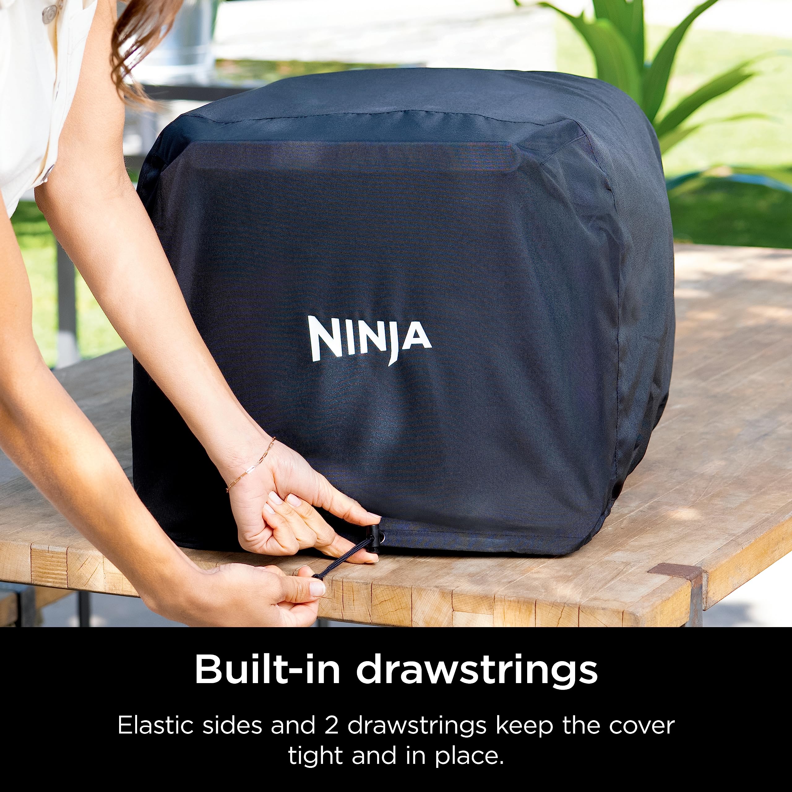 Ninja Woodfire cover material demonstrates water resistance in light rain.