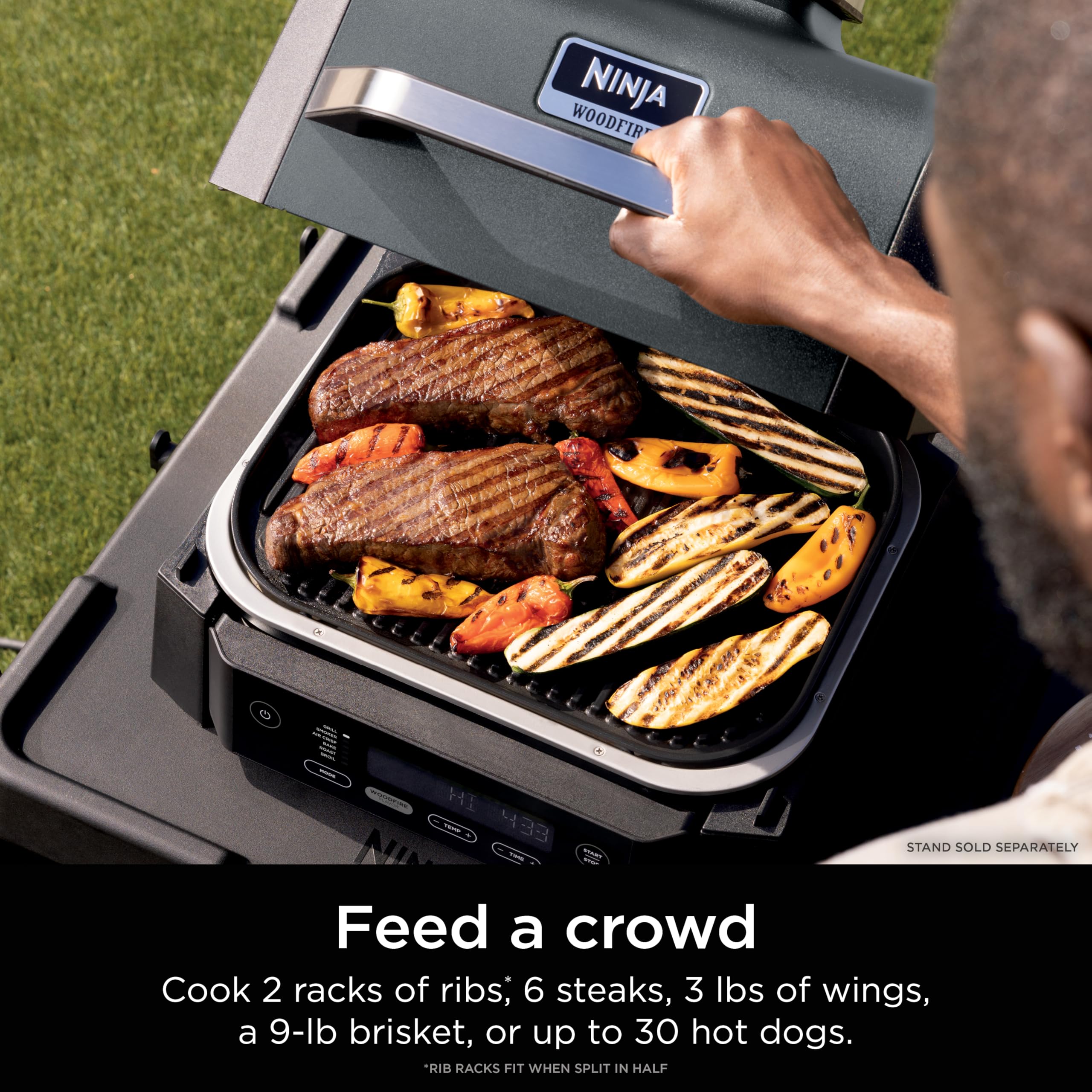 Ninja Woodfire Grill with lid open and grate visible for searing and grilling.