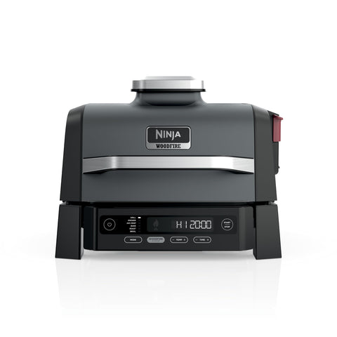Ninja Woodfire Grill on an outdoor patio shows all-in-one versatility for outdoor cooking.