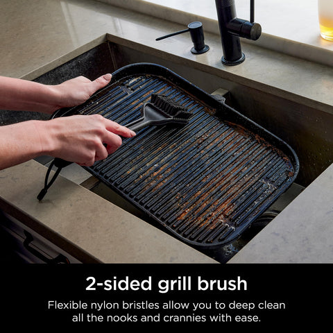 Ninja XSKBRUSHXL scraper fitting around grill grates to remove debris.