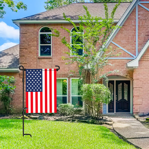 Nirohee flag holder for lawn shown with a flag, stable in light to moderate winds.