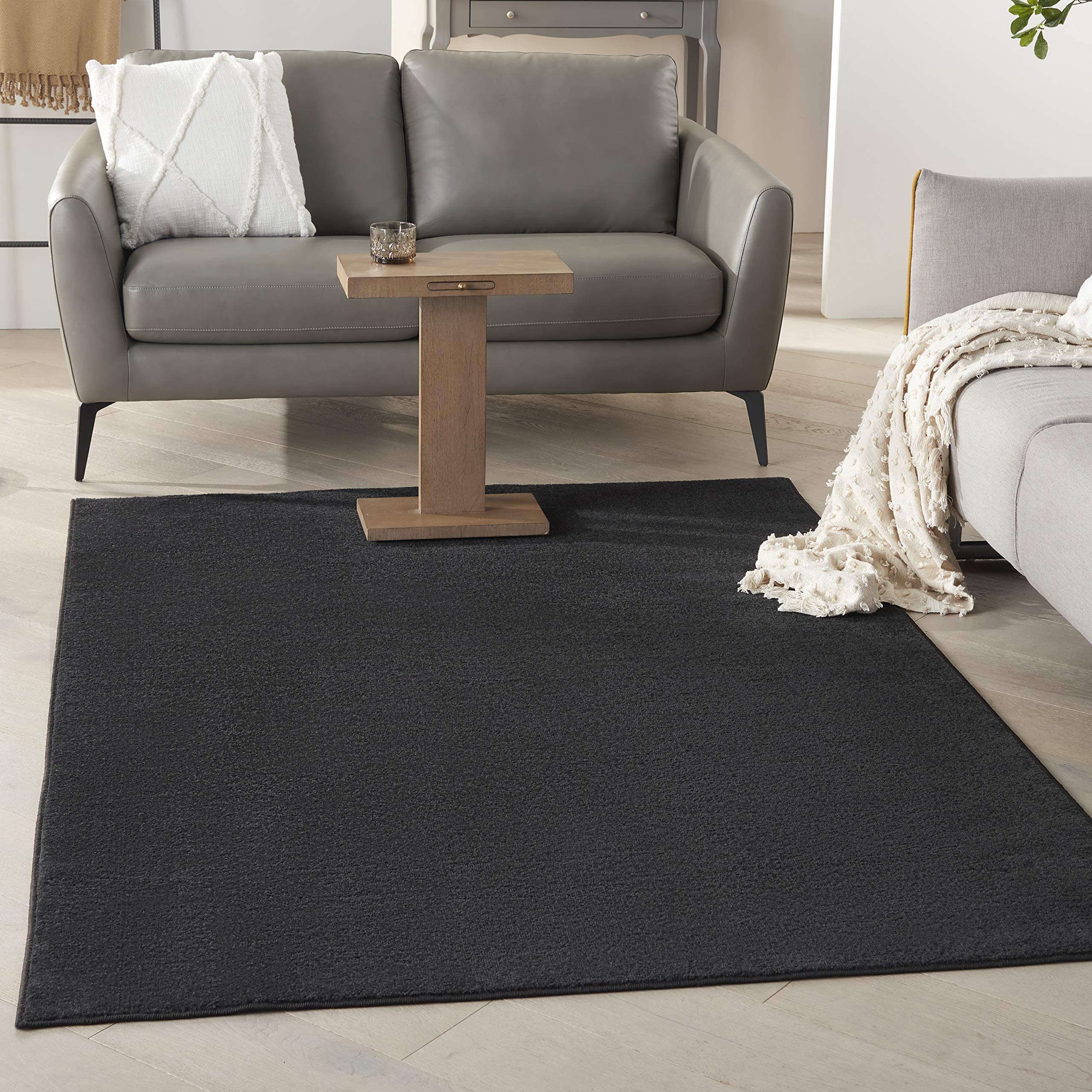 Nourison Essentials Black 5x7 area rug for versatile indoor-outdoor use with a soft underfoot.