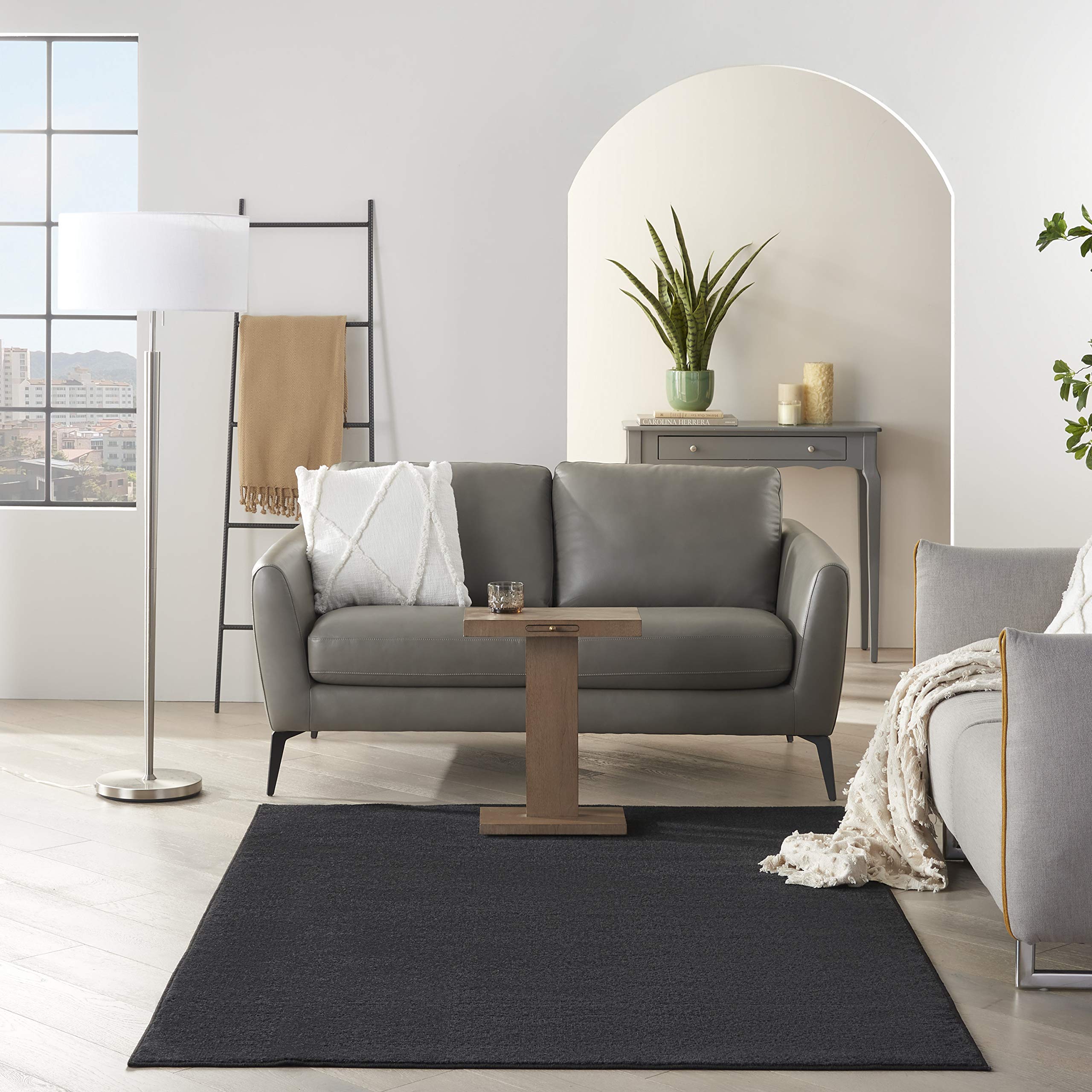Nourison Essentials Black easy-clean polypropylene rug cleans with vacuum or hose rinse.