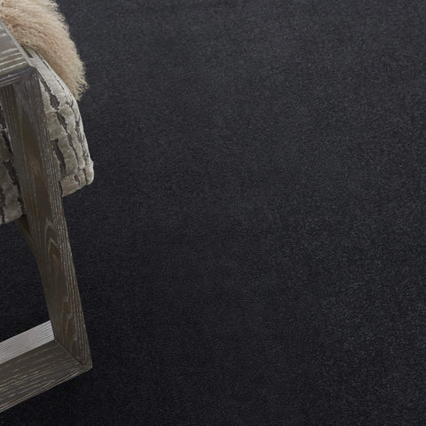 Nourison Essentials black rug edge-serged for a clean, durable border.