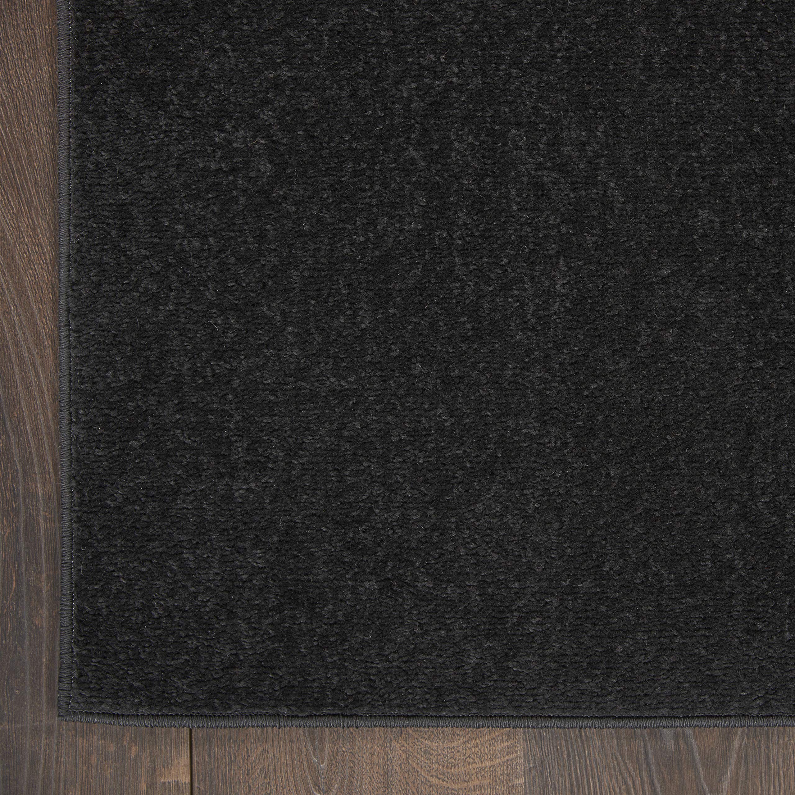 Nourison Essentials Black serged-edge rug offers durable construction and neat edges.