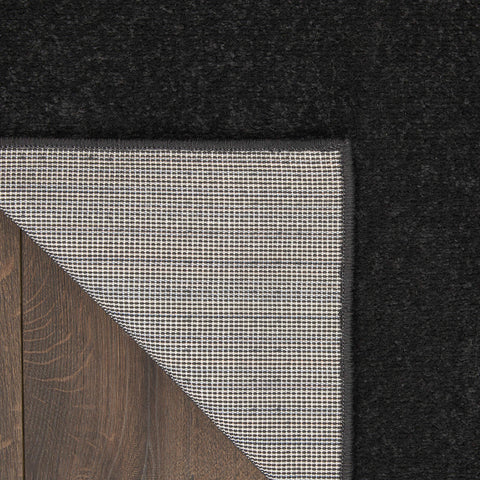 Nourison Essentials Black solid design suits modern interiors and easy layering.