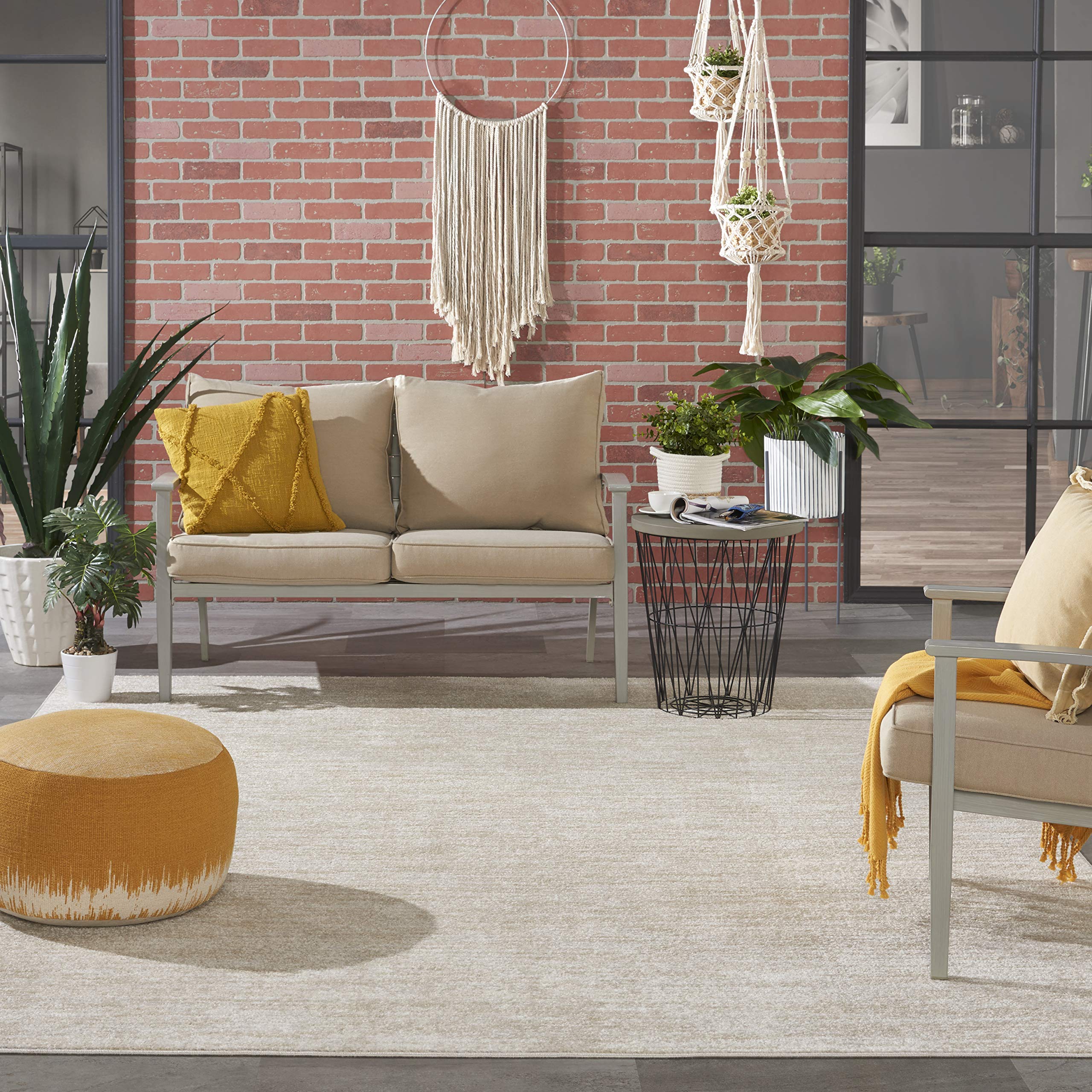 Nourison Essentials Ivory Beige 7x10 Rug porch setup illustrates outdoor-friendly durability