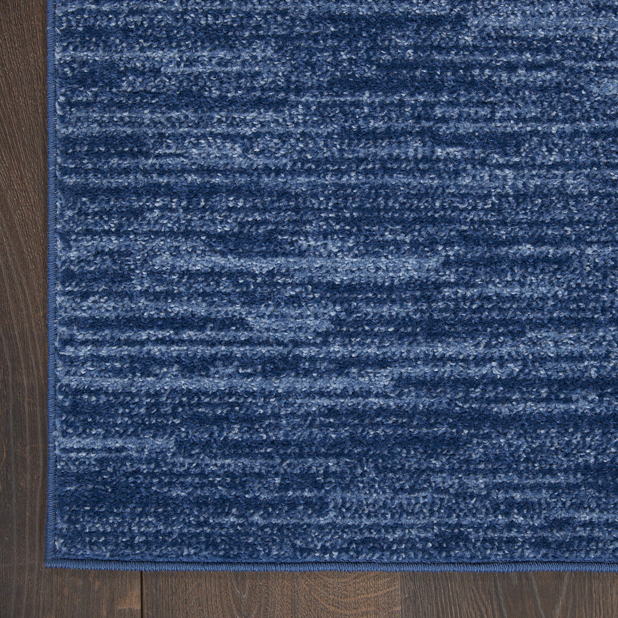 Nourison Essentials navy blue rug easy cleaning with vacuum or hose rinse