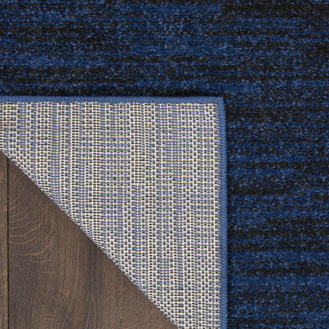 Nourison Essentials Midnight Blue rug on a patio setup