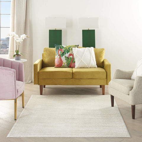 Nourison Home Essentials ivory-beige rug on porch scene highlights easy care.