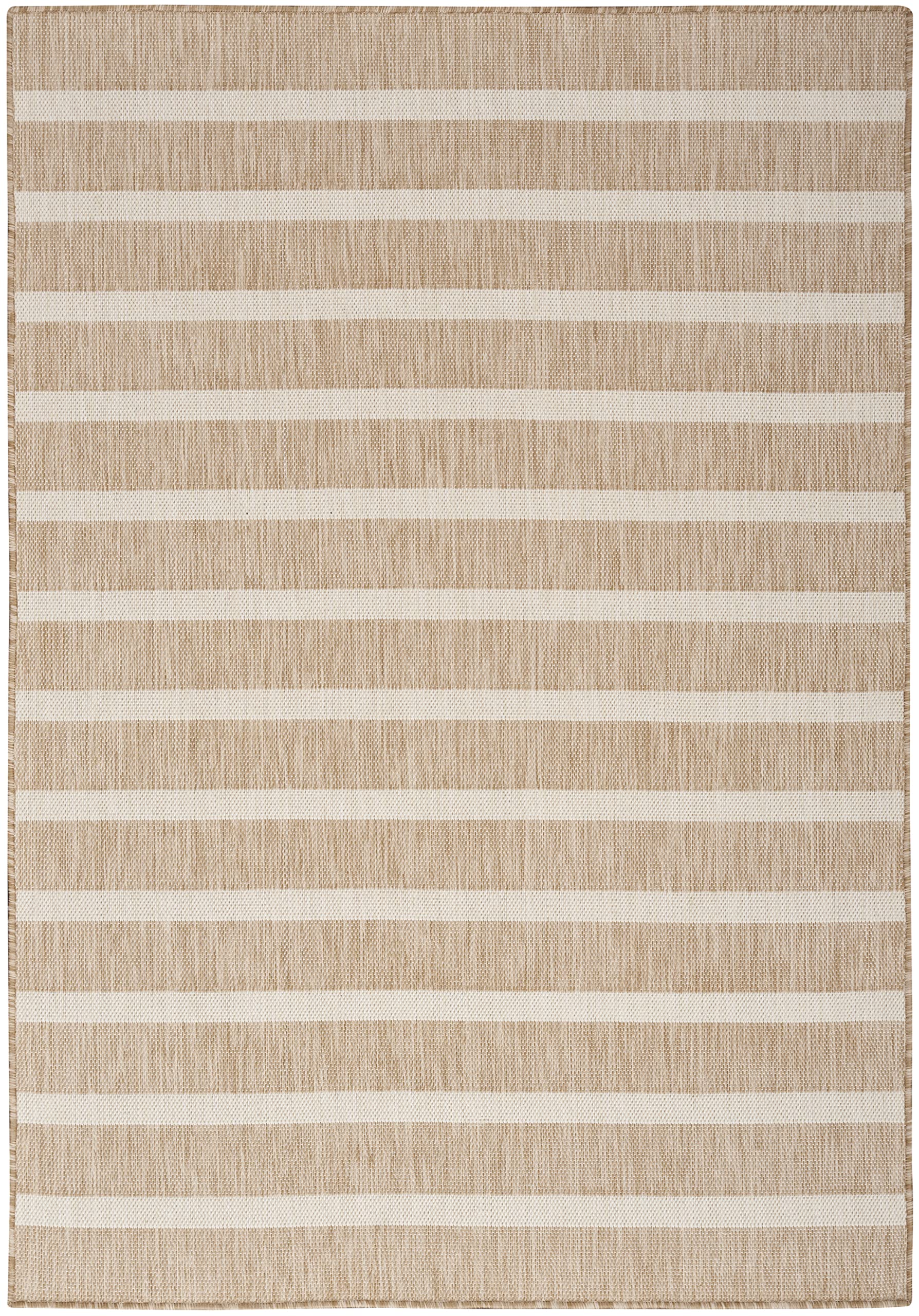 Nourison Positano beige ivory rug in a dining room with low-maintenance appeal.