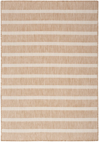 Nourison Positano beige ivory rug in a dining room with low-maintenance appeal.