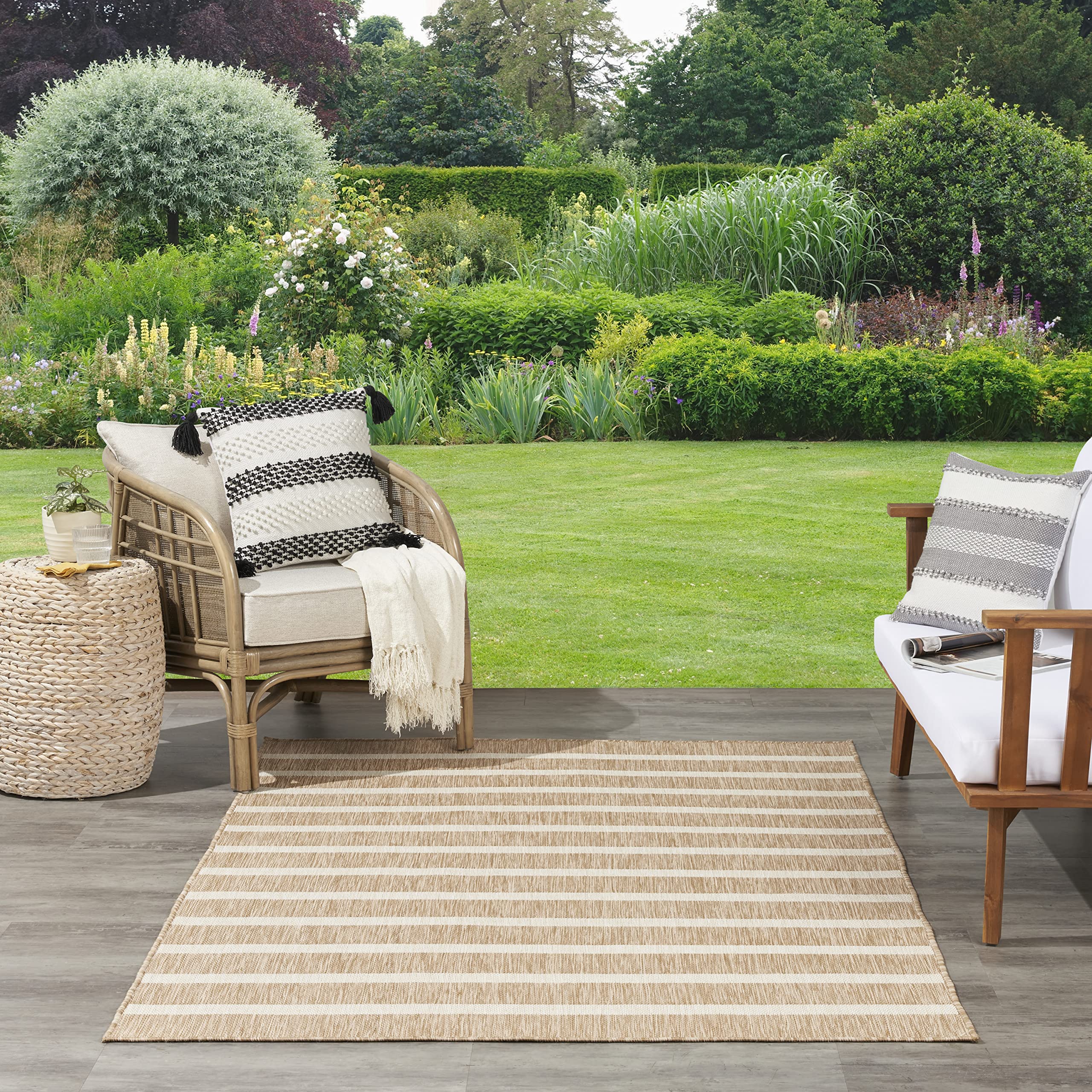 Nourison Positano beige ivory rug on a patio creating a casual seating area.