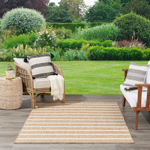 Nourison Positano beige ivory rug on a patio creating a casual seating area.