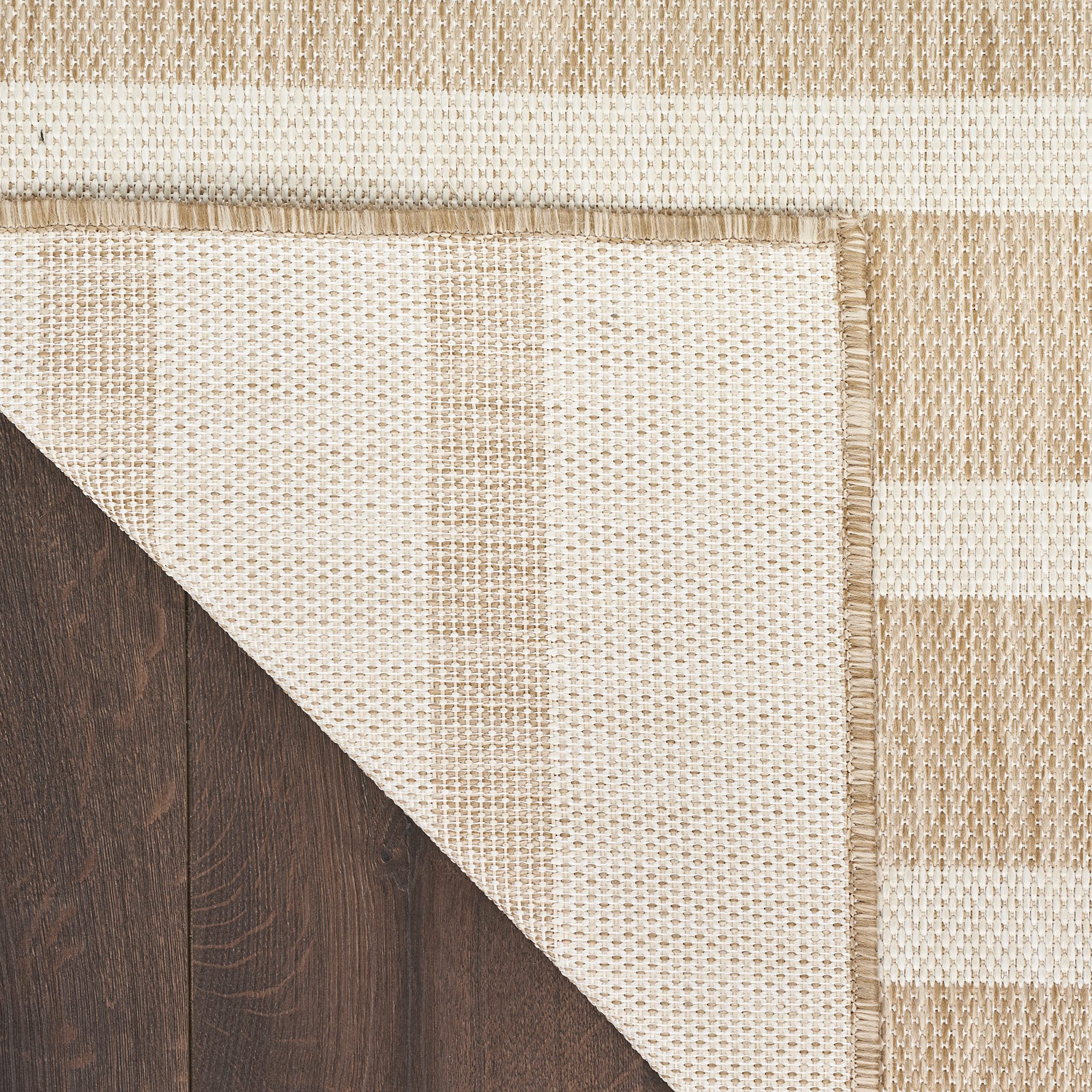 Nourison Positano beige ivory rug indoors with rug pad recommended for stability.