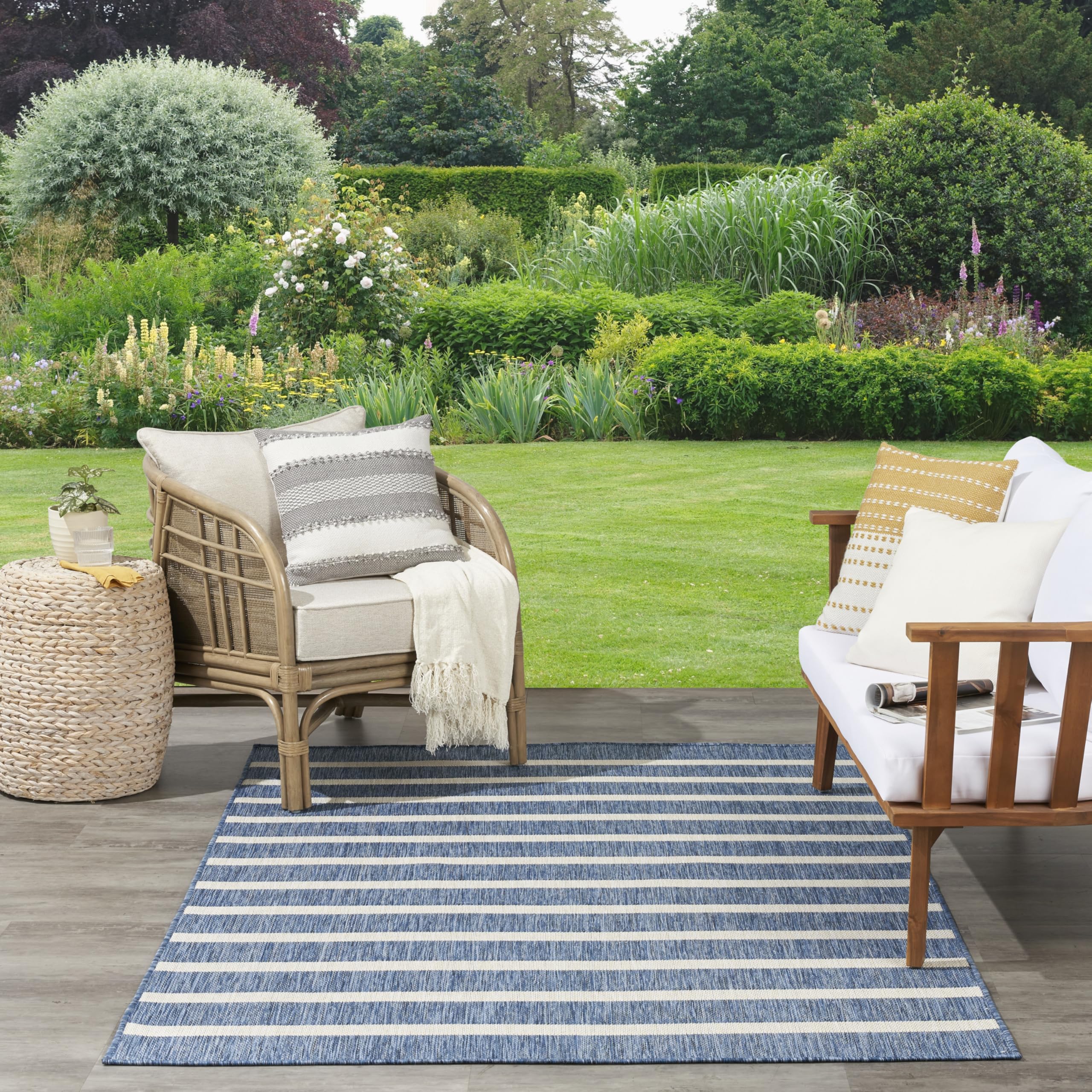 Nourison Positano outdoor patio setup with navy ivory rug