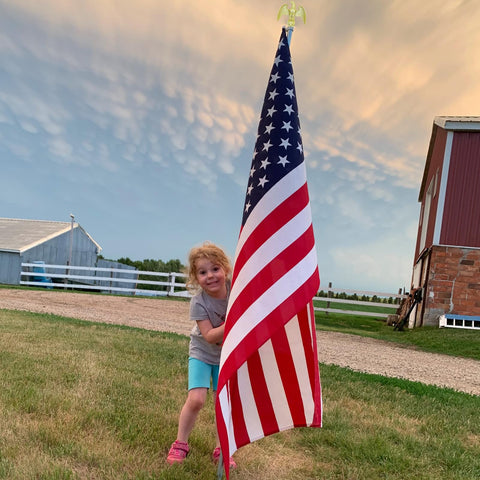 NQ flag pole on truck and boat showcases versatile outdoor use.