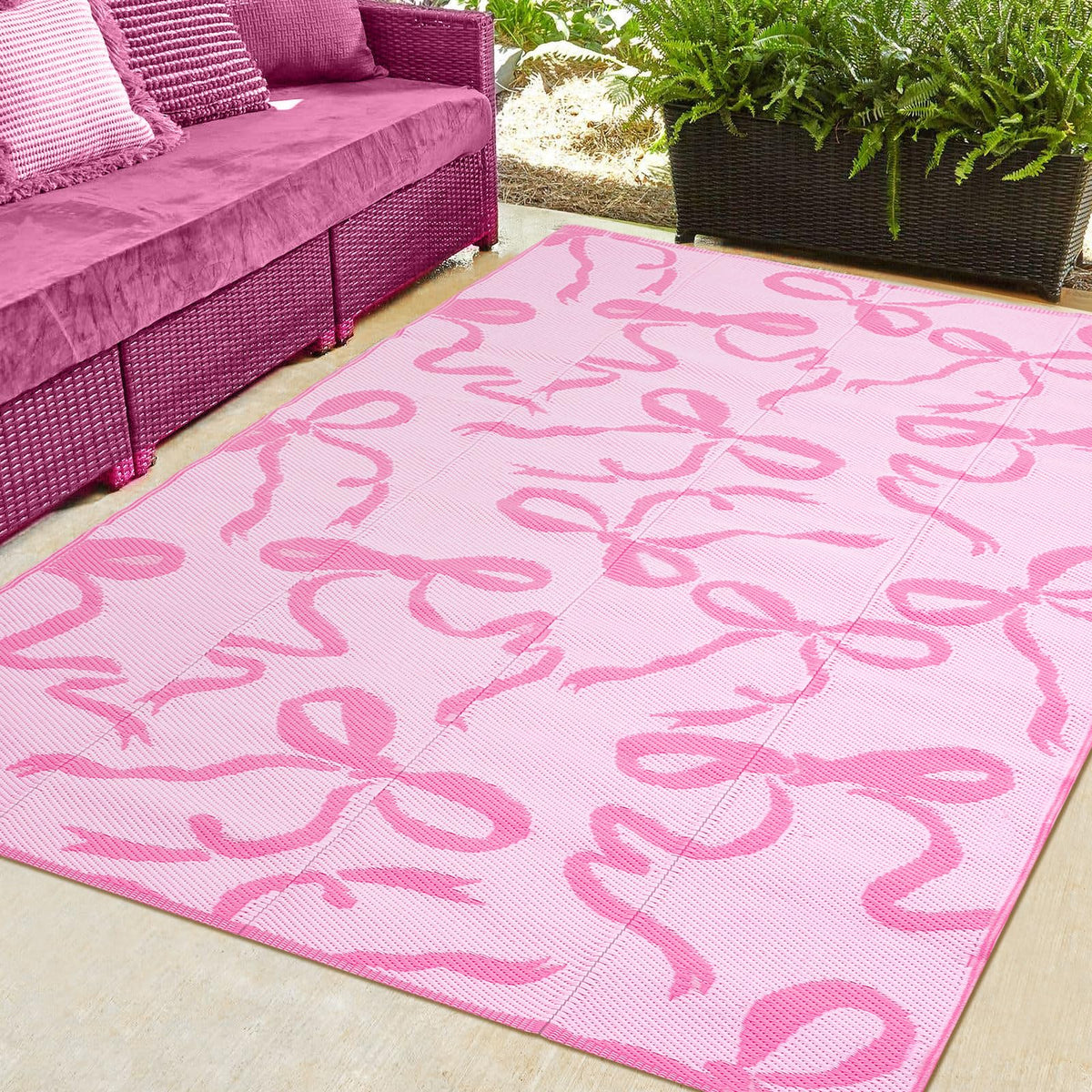 Nuanchu pink bow outdoor rug 5x8 ft offers soft barefoot comfort for patios and decks.
