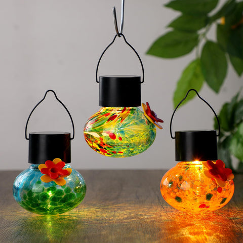 Nuogo solar-led hummingbird feeder night glow enhances garden ambiance after sunset.